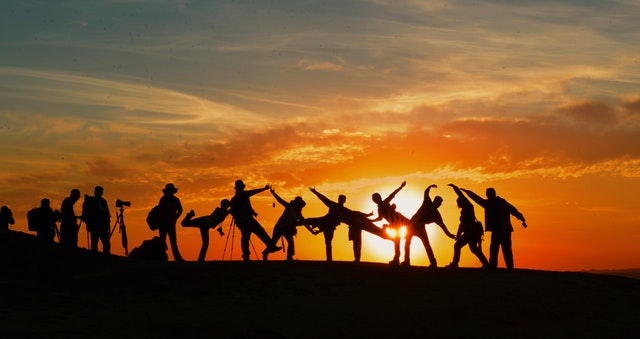 Imagem de pessoas juntas no pôr do sol simbolizando team coaching